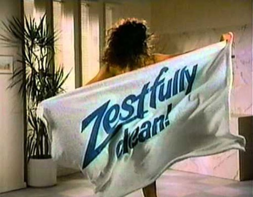 Woman holding a towel that says zestfully clean from a vintage television commercial